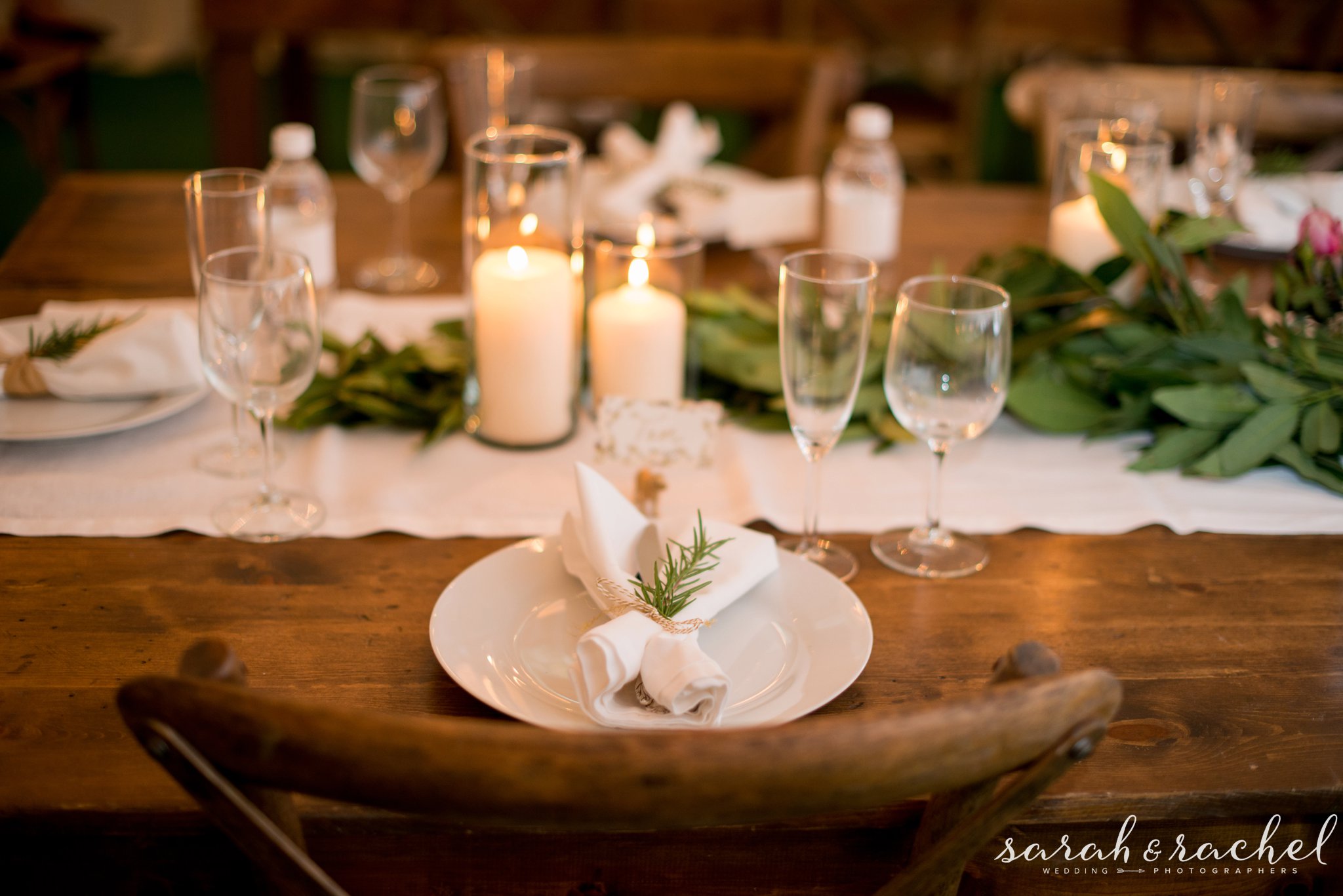 gorgeous barn wood tables wedding reception greenery and dog statue name cards