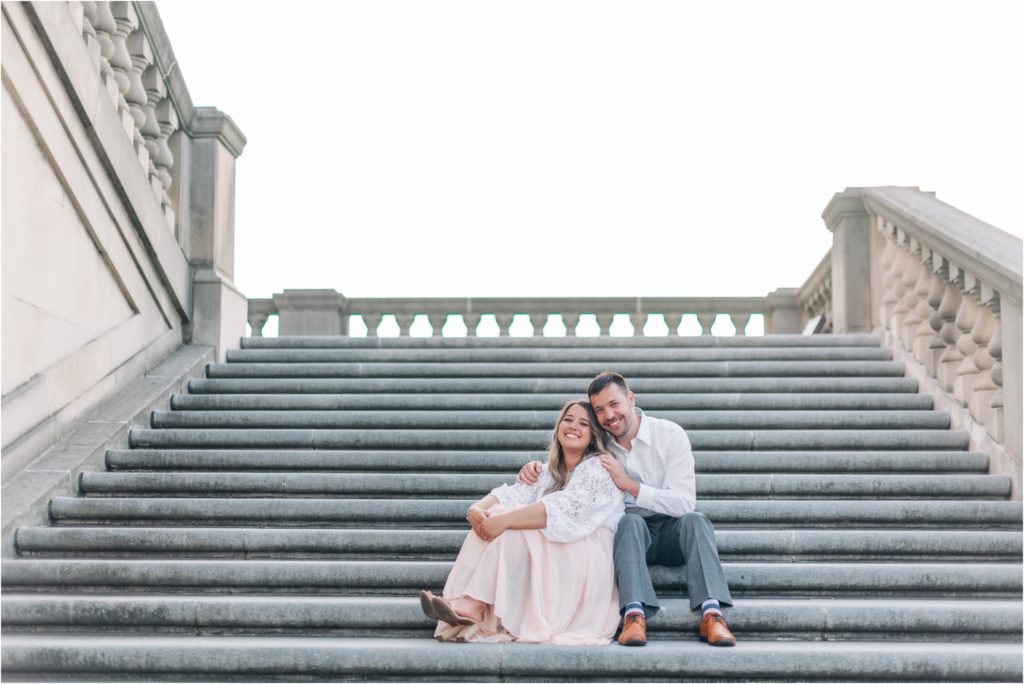 Couple sitting at the Indianapolis War Memorial for a beautiful Sunset Engagement Session