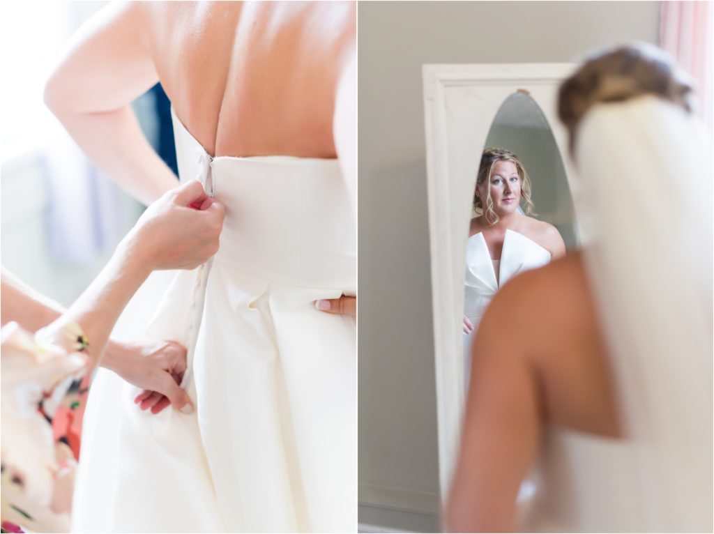 bride zipping up her dress and taking a final look in the mirror