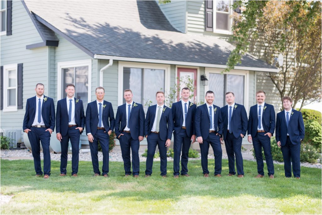 groomsmen posing in front of the getting ready house