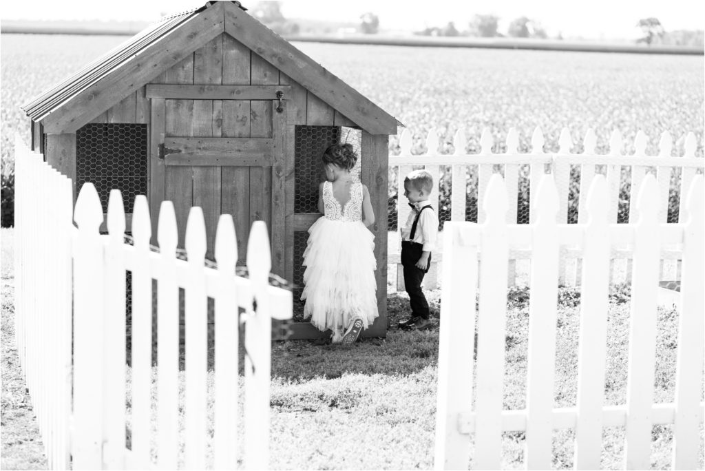 flower girl and ring bearer by chicken coop