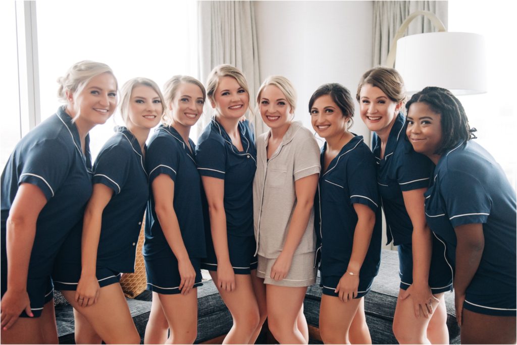 Fun getting ready bride and bridesmaids photo in hotel room 