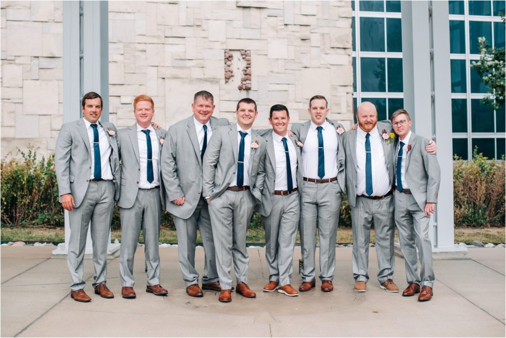 Groom and groomsmen with gray suits and navy blue ties