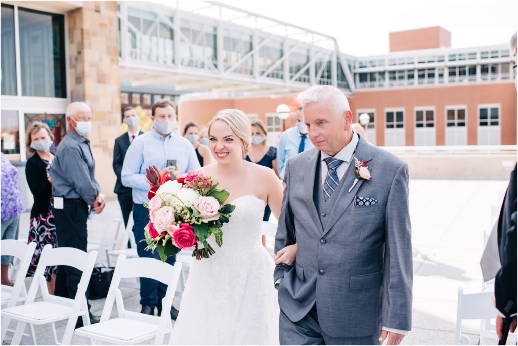 Bride walking with her father down the aisle at her outdoor ceremony in downtown Indianapolis 