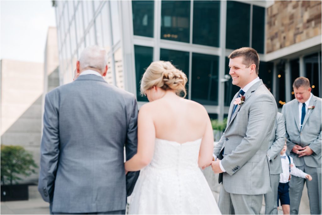 Bride walking with her father down the aisle at her outdoor ceremony in downtown Indianapolis at the Indiana State House
