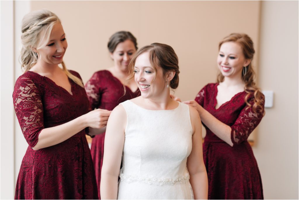 Maroon bridal gowns during getting ready photos at the central library in Indianapolis