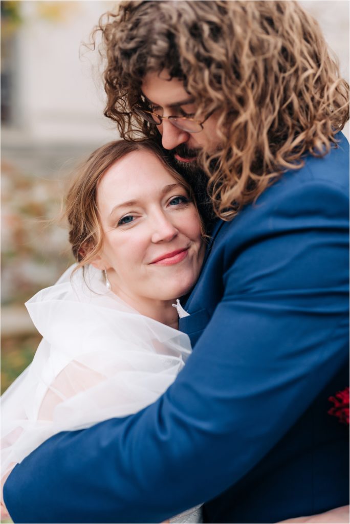 Bride and Groom hug in the East Garden and the Indianapolis Central Library