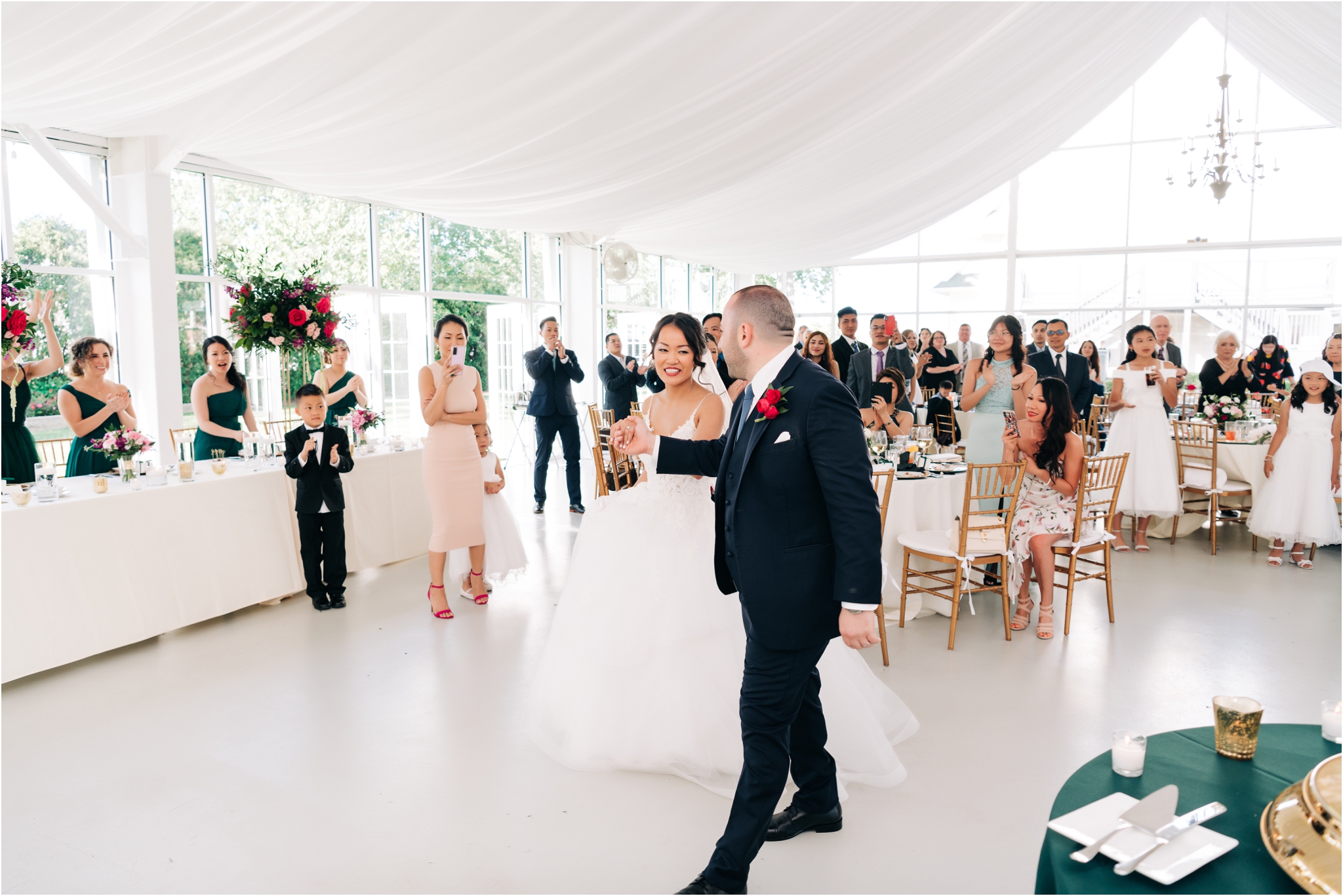 reception introduction of the bride and groom in glass pavilion