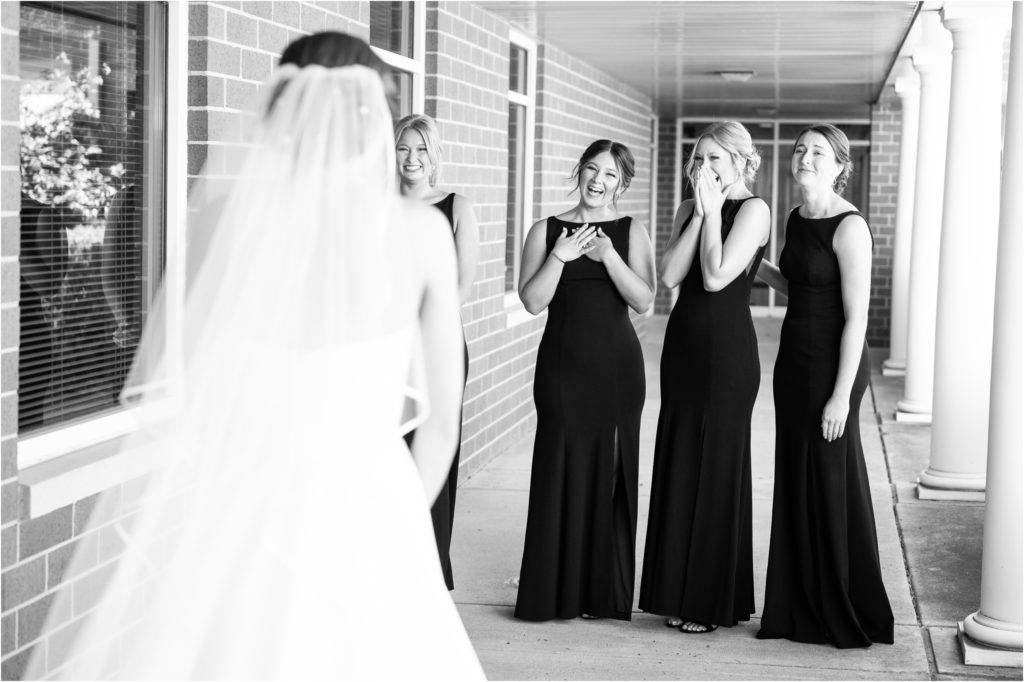 first look with bridesmaids at the chapel