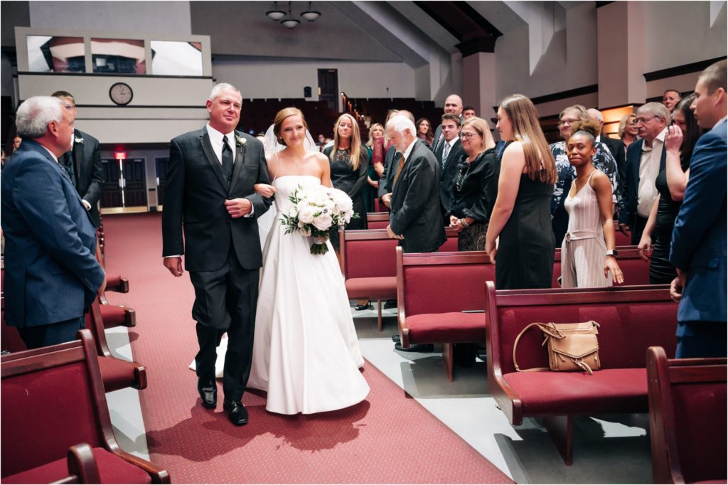 father walking his daughter down the aisle on her wedding day